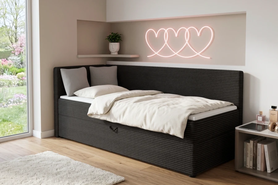 Schwarzes Kindersofa Roberto als gemütliches Bett mit weißer Bettwäsche in modernem Zimmer.