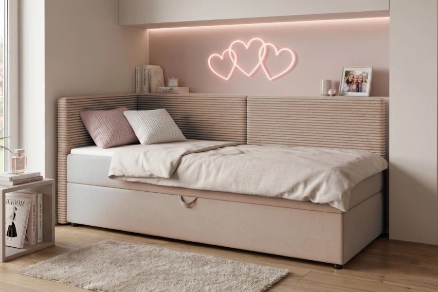 Einzel-Boxspringbett mit Bettkasten und Cord-Kopfteil unter einer romantischen Herz-Neonbeleuchtung.