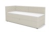 Cremefarbenes Boxspringbett mit geripptem Kopfteil, Ausführung Links.