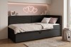 Boxspringbett für Jugendzimmer mit rosa Wanddeko und grauem Cord-Kopfteil.