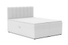 Modernes weißes Boxspringbett mit gepolstertem Kopfteil und hohem Liegekomfort.