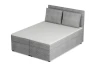 Modernes hellgraues Boxspringbett aus Cordstoff mit Kopfteil und Kissen, schräge Ansicht.