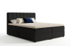 Schwarzes Boxspringbett mit Cord-Bezug und hohem Kopfteil vor weißem Hintergrund.