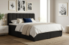Modernes Boxspringbett in Schwarz mit Cord-Optik in einem hellen Schlafzimmer.
