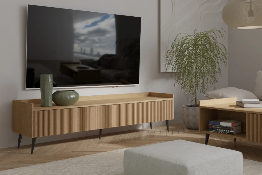 Modernes TV-Board aus Eiche mit Lamellenfront und schwarzen Füßen im minimalistischen Wohnzimmer.