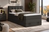 Dunkelgraues Boxspringbett mit gepolstertem Kopfteil in modernem Schlafzimmer.