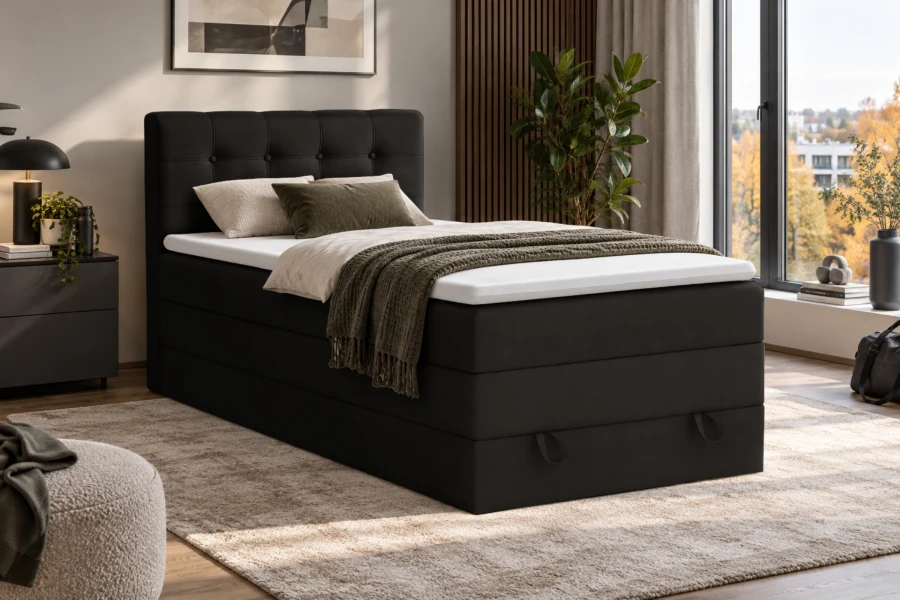Schwarzes Boxspringbett mit Steppung im Kopfteil in modernem Interieur.