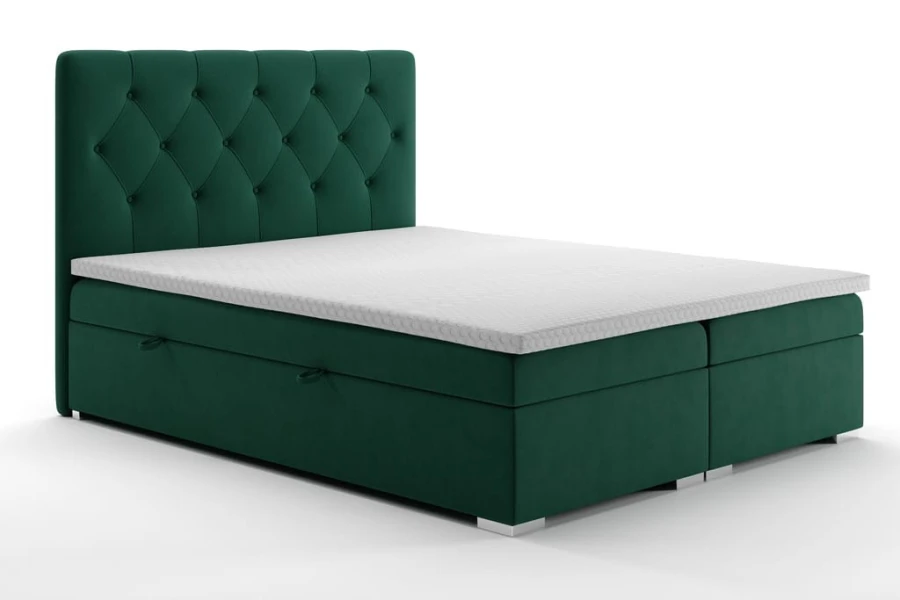 Dunkelgrünes Boxspringbett aus Samt mit gepolstertem Kopfteil und Bettkasten.