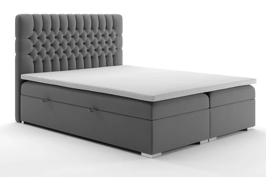 Graues Boxspringbett mit gestepptem Kopfteil und Bettkasten auf weißem Hintergrund.