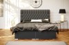 Stilvolles graues Polsterbett in einem hellen, modern eingerichteten Schlafzimmer-Ambiente.