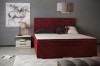 Elegantes Boxspring-Doppelbett in Weinrot mit Samtbezug für ein luxuriöses Schlafzimmer.