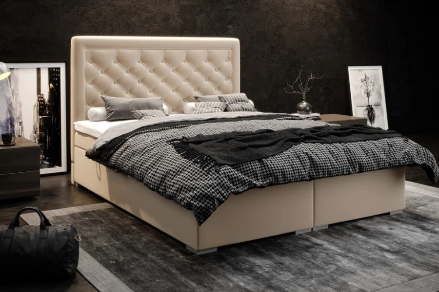Beiges Boxspringbett mit Knopfheftung am Kopfteil in modernem Schlafzimmer.
