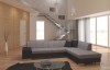 Zweifarbiges Ecksofa in Schwarz und Grau im modernen Wohnbereich mit Fensterfront.